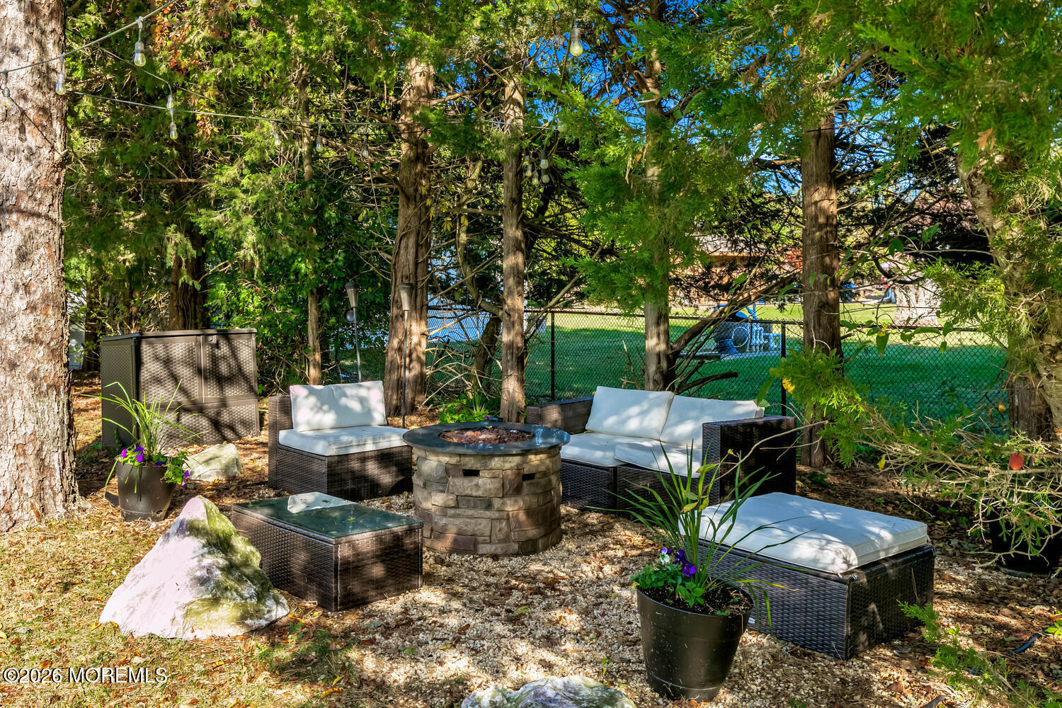 46 Woodview Drive Howell, NJ 07731 - Photo 16 of 17 a view of a patio with table and chairs potted plants and large tree