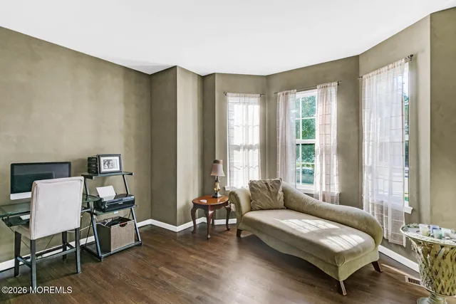 a bedroom with furniture and a large window