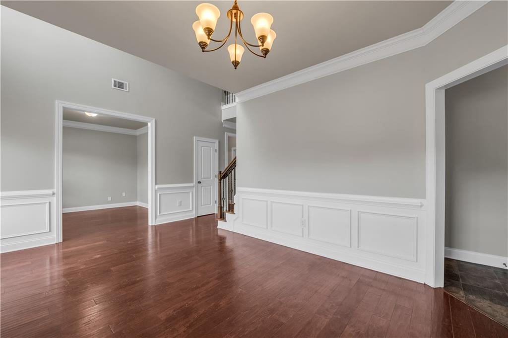 2626 Holden Spring Drive Dacula, GA 30019 - Photo 16 of 62 a view of an empty room with a window and wooden floor