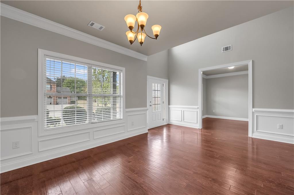 2626 Holden Spring Drive Dacula, GA 30019 - Photo 17 of 62 a view of an empty room with wooden floor and a window