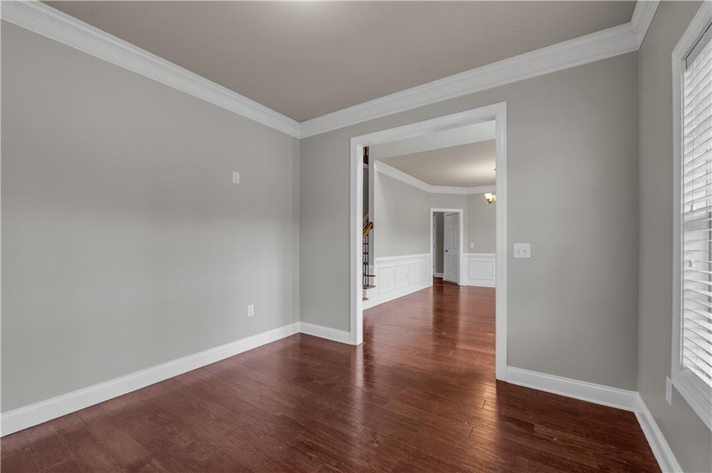 2626 Holden Spring Drive Dacula, GA 30019 - Photo 20 of 62 a view of empty room with wooden floor and window