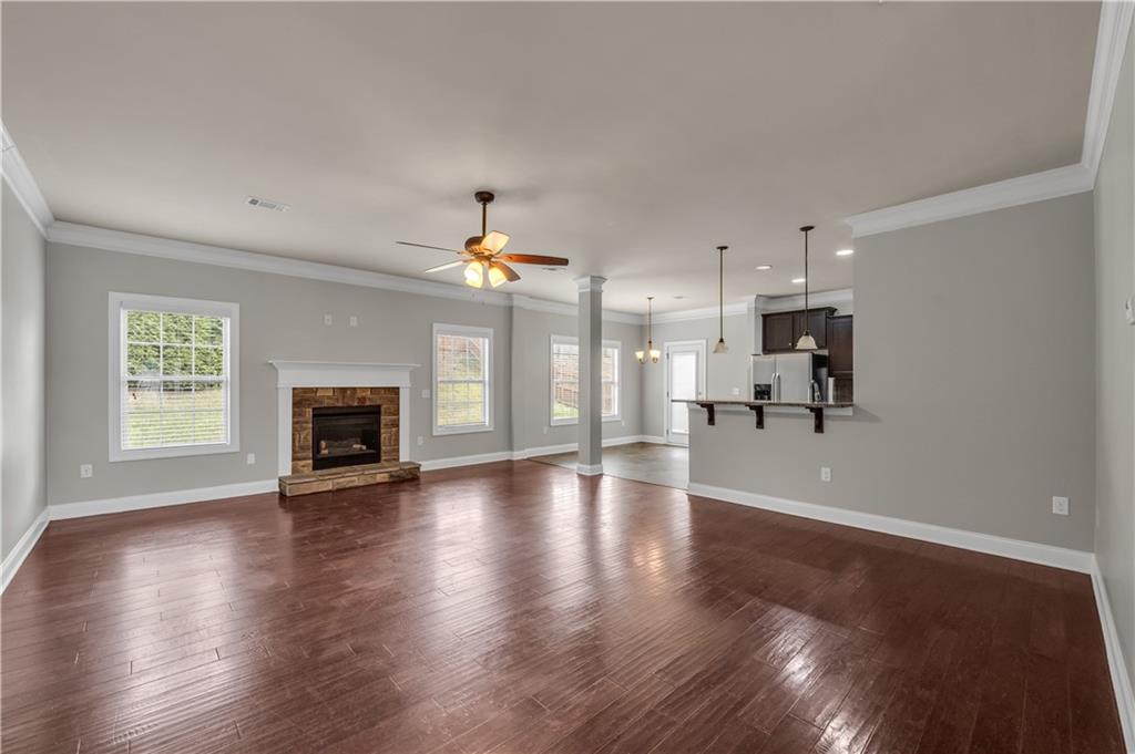 2626 Holden Spring Drive Dacula, GA 30019 - Photo 22 of 62 a view of an empty room with wooden floor and a fireplace