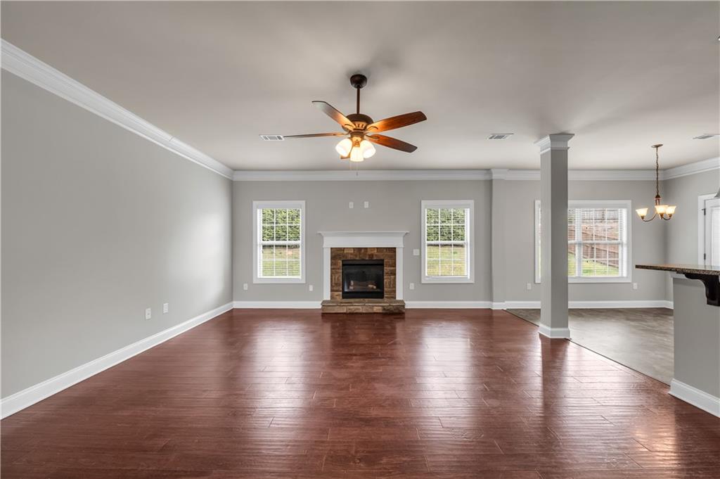 2626 Holden Spring Drive Dacula, GA 30019 - Photo 26 of 62 a view of an empty room with wooden floor and a fireplace
