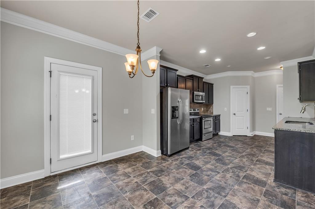 2626 Holden Spring Drive Dacula, GA 30019 - Photo 27 of 62 a view of a kitchen with a sink and a refrigerator
