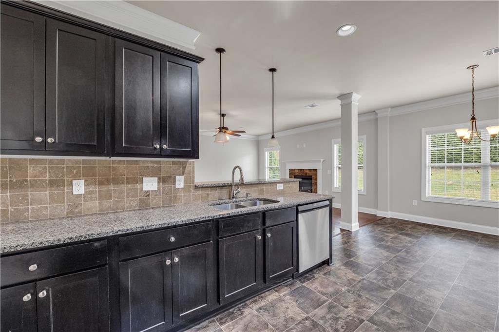 2626 Holden Spring Drive Dacula, GA 30019 - Photo 33 of 62 a kitchen with stainless steel appliances granite countertop wooden cabinets a sink and dishwasher