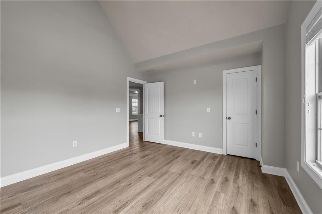 2626 Holden Spring Drive Dacula, GA 30019 - Photo 42 of 62 a view of an empty room with wooden floor and a window