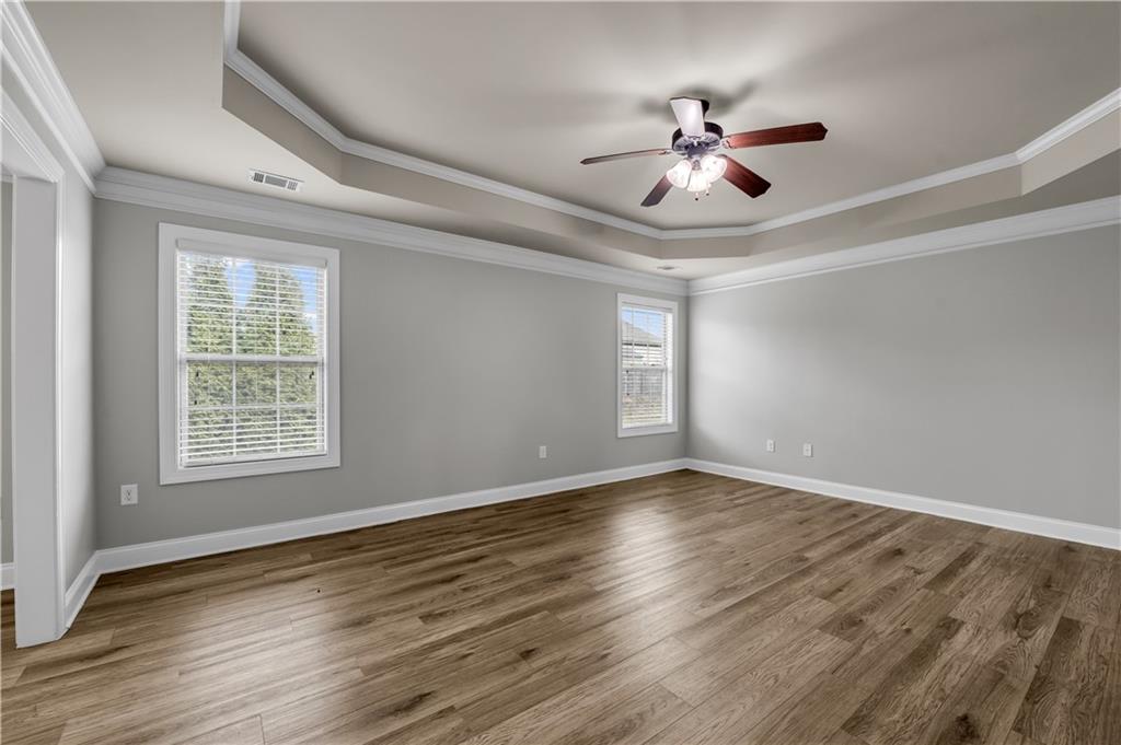 2626 Holden Spring Drive Dacula, GA 30019 - Photo 45 of 62 a view of an empty room with wooden floor and a window