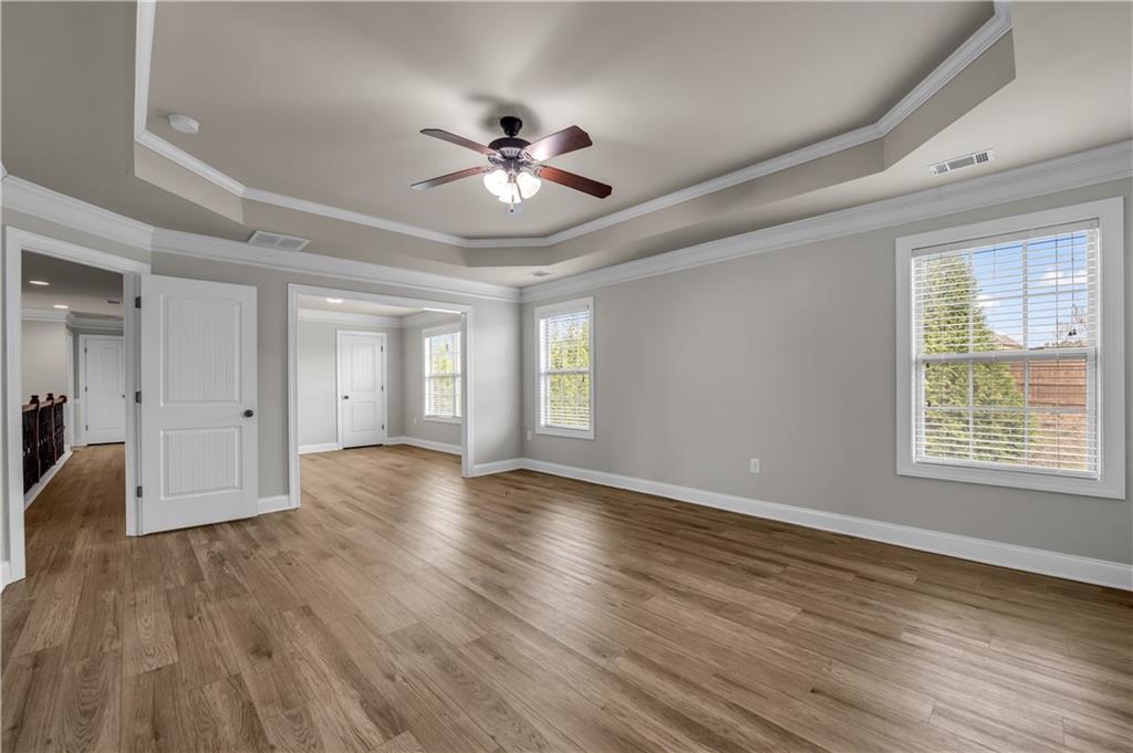 2626 Holden Spring Drive Dacula, GA 30019 - Photo 46 of 62 a view of an empty room with wooden floor and a window