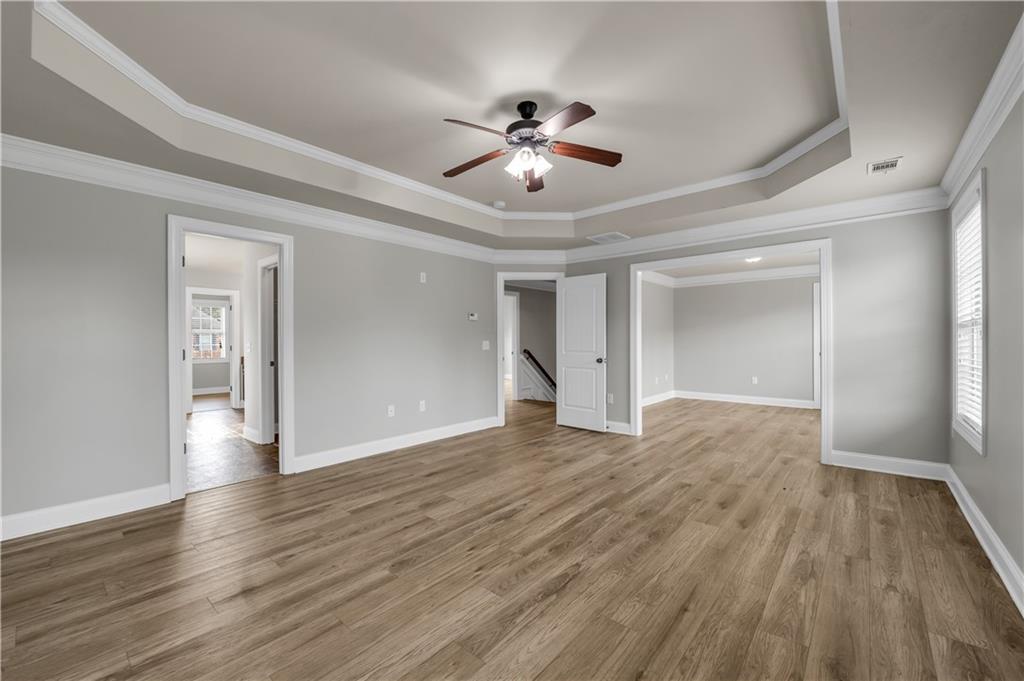 2626 Holden Spring Drive Dacula, GA 30019 - Photo 47 of 62 a view of an empty room and wooden floor