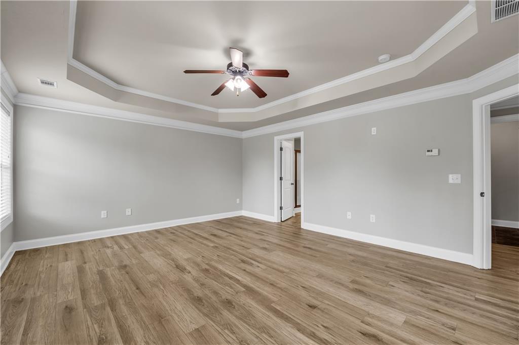 2626 Holden Spring Drive Dacula, GA 30019 - Photo 48 of 62 a view of an empty room with wooden floor