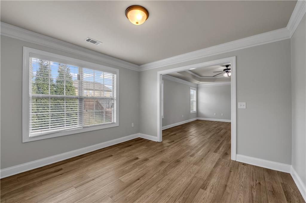 2626 Holden Spring Drive Dacula, GA 30019 - Photo 50 of 62 a view of an empty room with wooden floor and a window