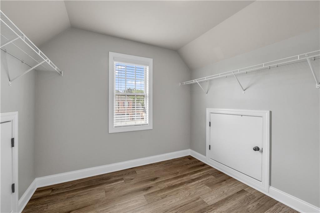 2626 Holden Spring Drive Dacula, GA 30019 - Photo 54 of 62 a view of an empty room with wooden floor and a window