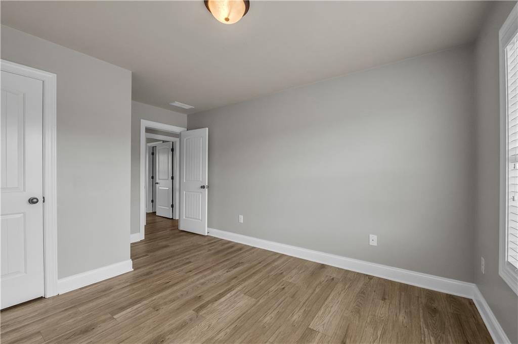 2626 Holden Spring Drive Dacula, GA 30019 - Photo 57 of 62 a view of an empty room and wooden floor
