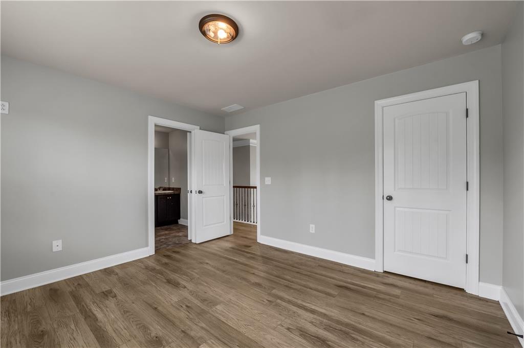 2626 Holden Spring Drive Dacula, GA 30019 - Photo 60 of 62 a view of an empty room with wooden floor