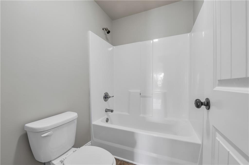 2626 Holden Spring Drive Dacula, GA 30019 - Photo 62 of 62 a white toilet sitting next to a bath tub