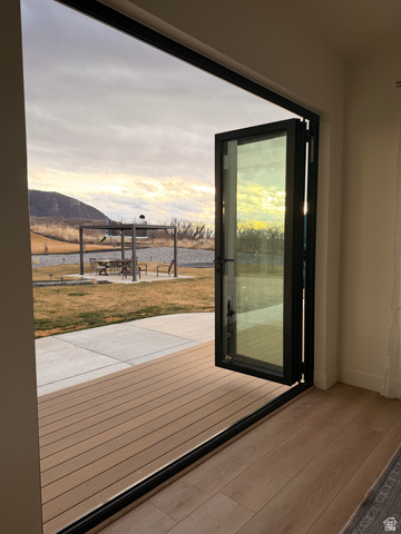 3626 Riverstone Road Mapleton, UT 84664 - Photo 48 of 58 Doorway to outside with a water and mountain view and wood finished floors