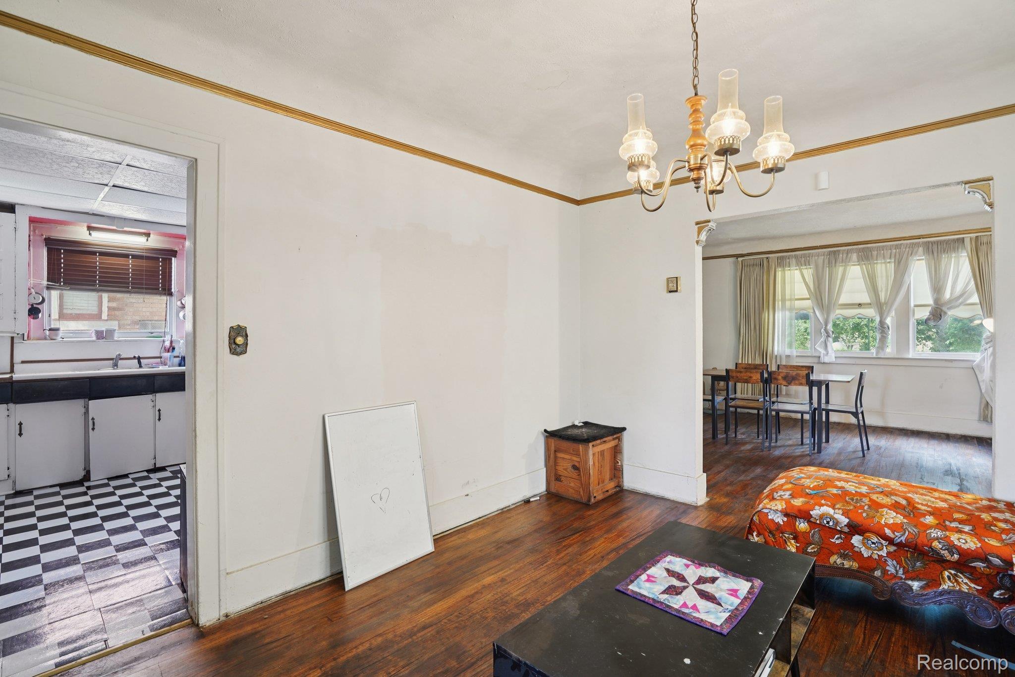 4101 Pasadena Street Detroit, MI 48238 - Photo 19 of 42 Hardwood flooring, cased openings, and a classic chandelier