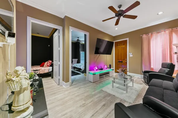 a living room with furniture and a flat screen tv