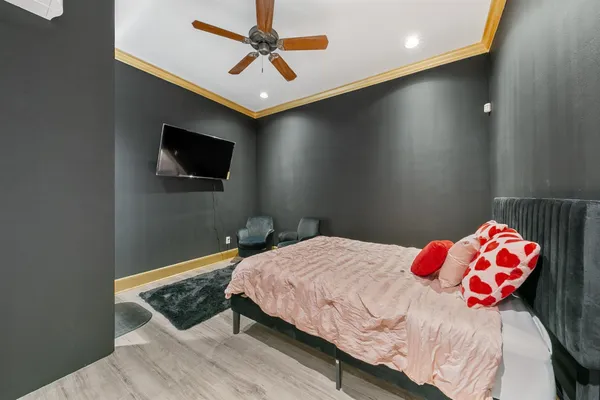 a bedroom with a bed and a flat screen tv