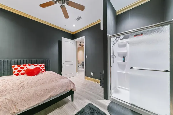 a bedroom with a bed and a potted plant