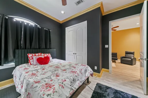 a bedroom with a bed and a large mirror