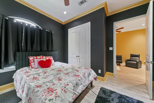 a bedroom with a bed and a large mirror