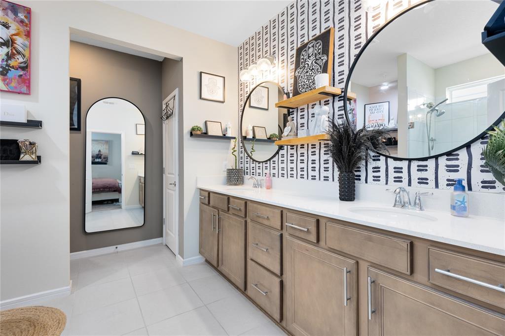 6528 Rover Way St. Cloud, FL 34771 - Photo 12 of 26 a spacious bathroom with a double vanity sink and a mirror