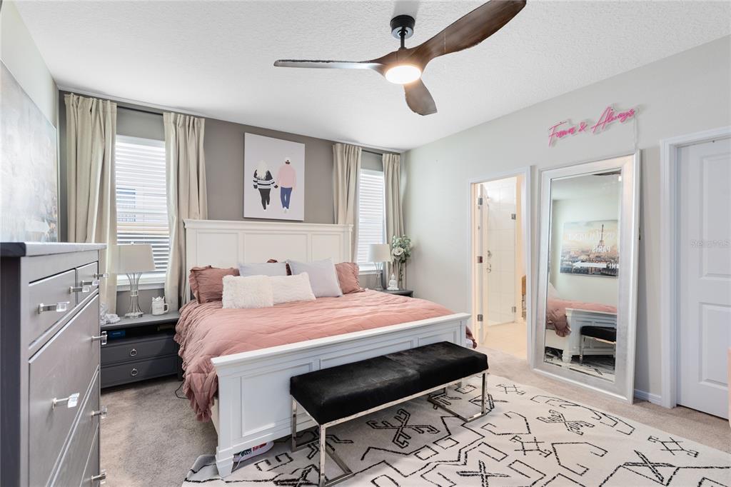 6528 Rover Way St. Cloud, FL 34771 - Photo 10 of 26 a bedroom with a bed and a chandelier