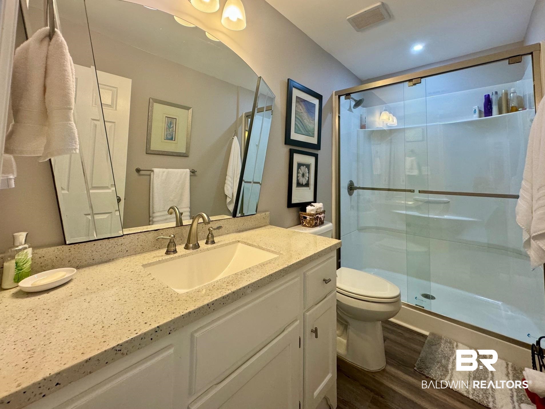 3200 Loop Road, Unit 55 Orange Beach, AL 36561 - Photo 25 of 40 Bathroom with vanity, a shower with door, toilet, and wood-type flooring