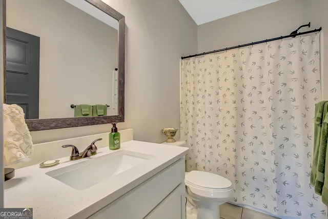 a dining room filled chandelier and kitchen view