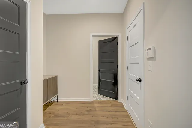 a living room with furniture a rug and white walls