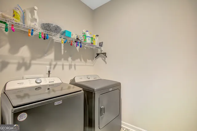 a kitchen with kitchen island granite countertop a stove a sink a center island and cabinets