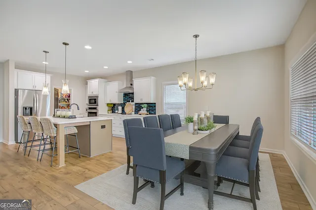 a kitchen with white cabinets and appliances