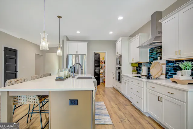 a bedroom with a bed and a flat tv screen on dresser