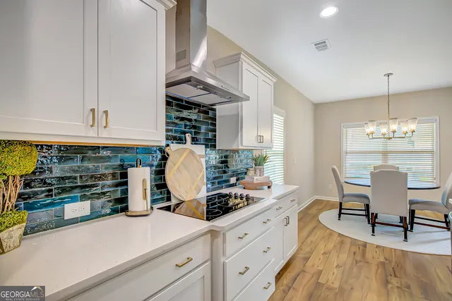 a bathroom with a tub a potted plant and a window