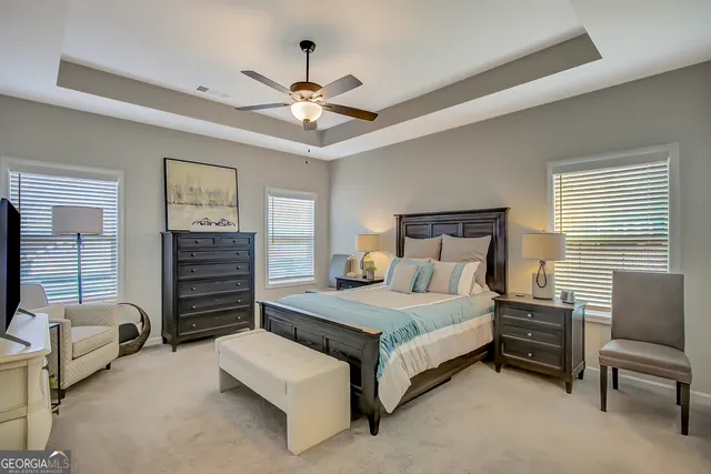 a front view of a house with outdoor seating and a yard