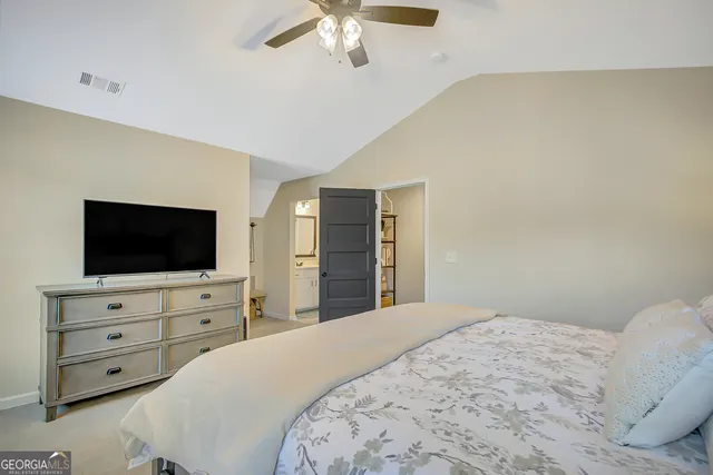 a living room with patio furniture and a potted plant