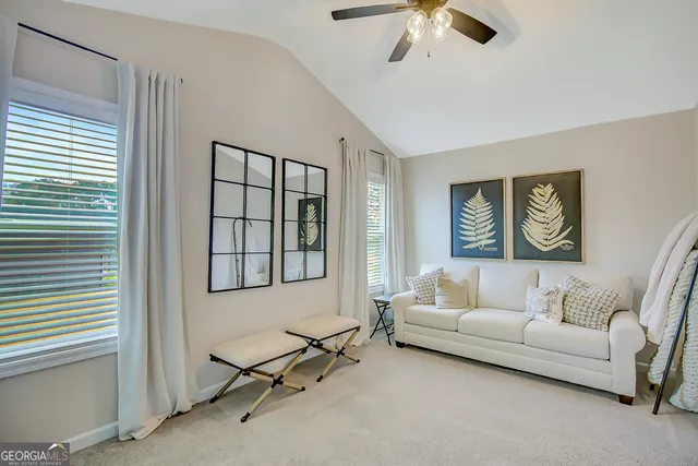 a view of a swimming pool with lawn chairs and a fire pit