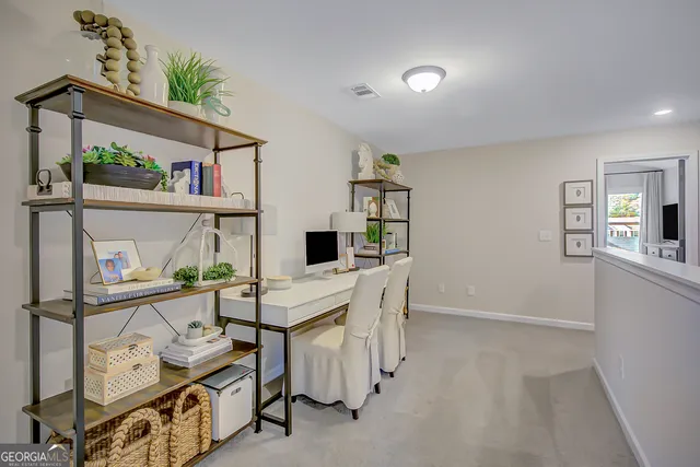 a view of a house with a yard and sitting area