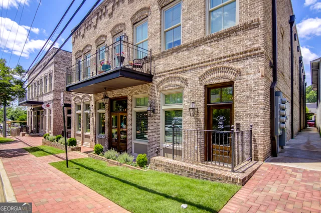 a kitchen with a sink a counter top space stainless steel appliances and cabinets