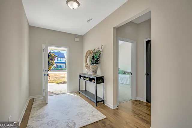 a view of a dining room with furniture a chandelier and wooden floor