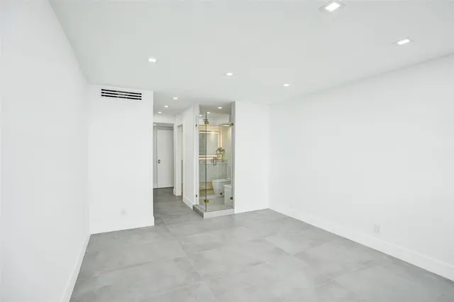 a large white kitchen with a sink and dishwasher a refrigerator with white cabinets