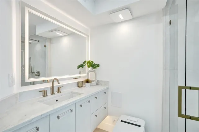 a kitchen with granite countertop white cabinets and stainless steel appliances