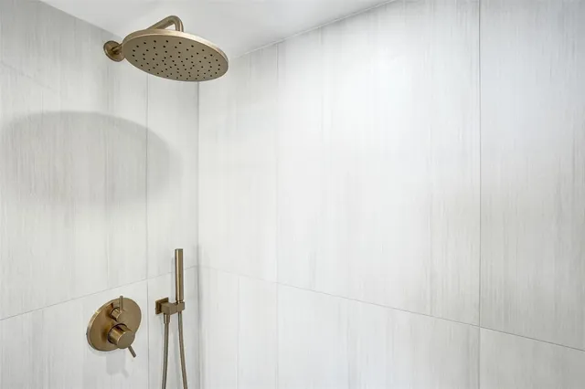 a kitchen with stainless steel appliances kitchen island granite countertop a refrigerator and a sink