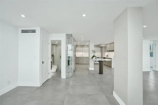 a view of kitchen with refrigerator and window