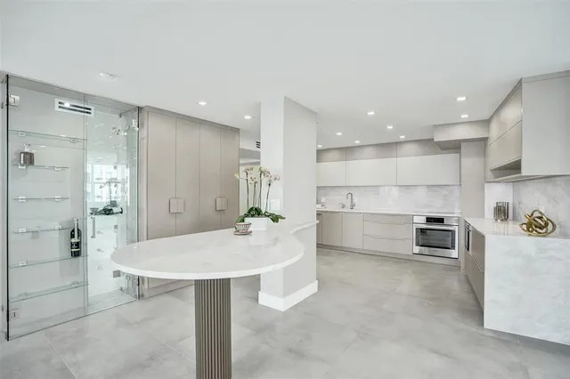 a bathroom with a granite countertop sink and shower