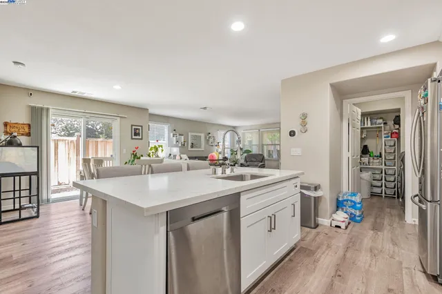 a kitchen with sink stove and wooden floor