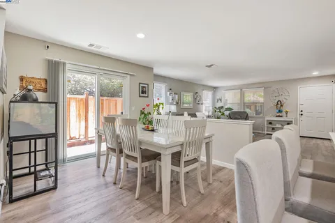 a dining room with furniture and wooden floor