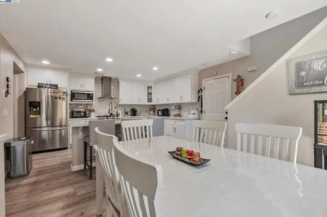a kitchen with white cabinets and stainless steel appliances