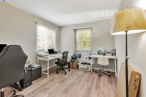 a view of a workspace with furniture and a window
